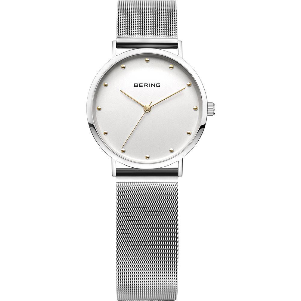 Reloj clásico de mujer con malla plateada y detalles dorados